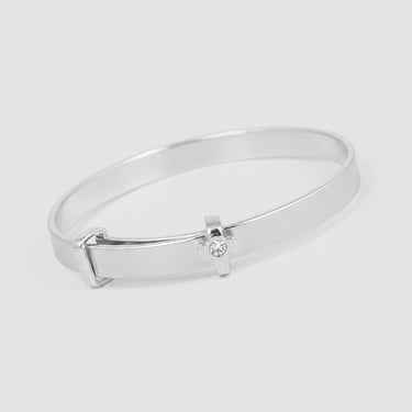 Silver bracelet with a small diamond on a dark surface